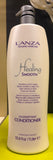 L'ANZA Healing Smooth conditioner bottle on a green surface with a blurred background